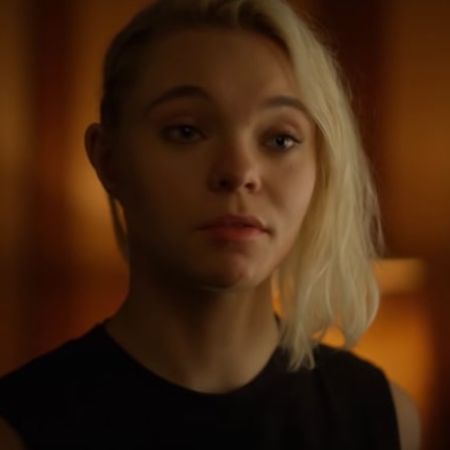 Taylor Hickson has short blonde hair as she is talking to someone.